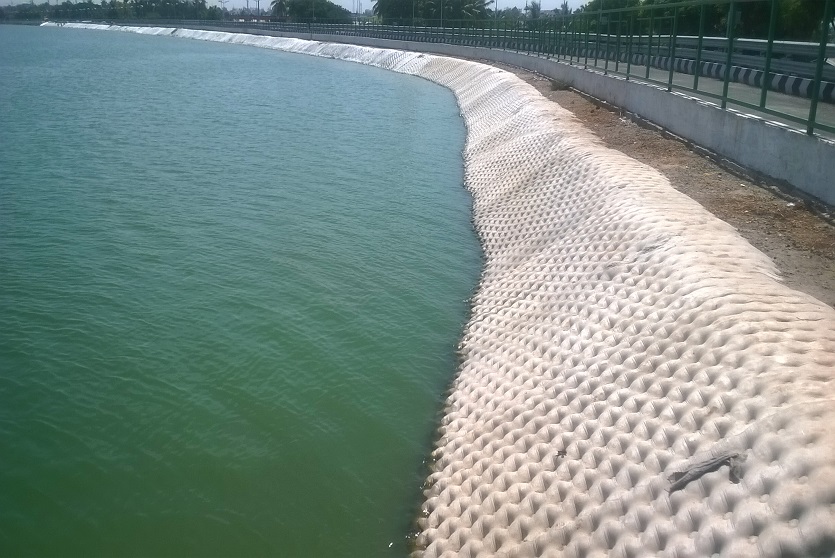 The geotextile, TechRevetment™ formed concrete mattresses, part of the geosynthetics solutions for erosion control. Pictured on the side of a lake.