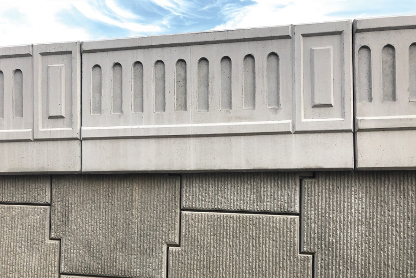 Precast concrete road barriers and parapets on a bridge.