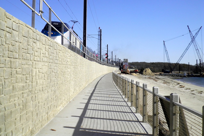 The T-Wall precast modular retaining wall by Geoquest pictured used as a retaining wall for rail infrastructure.