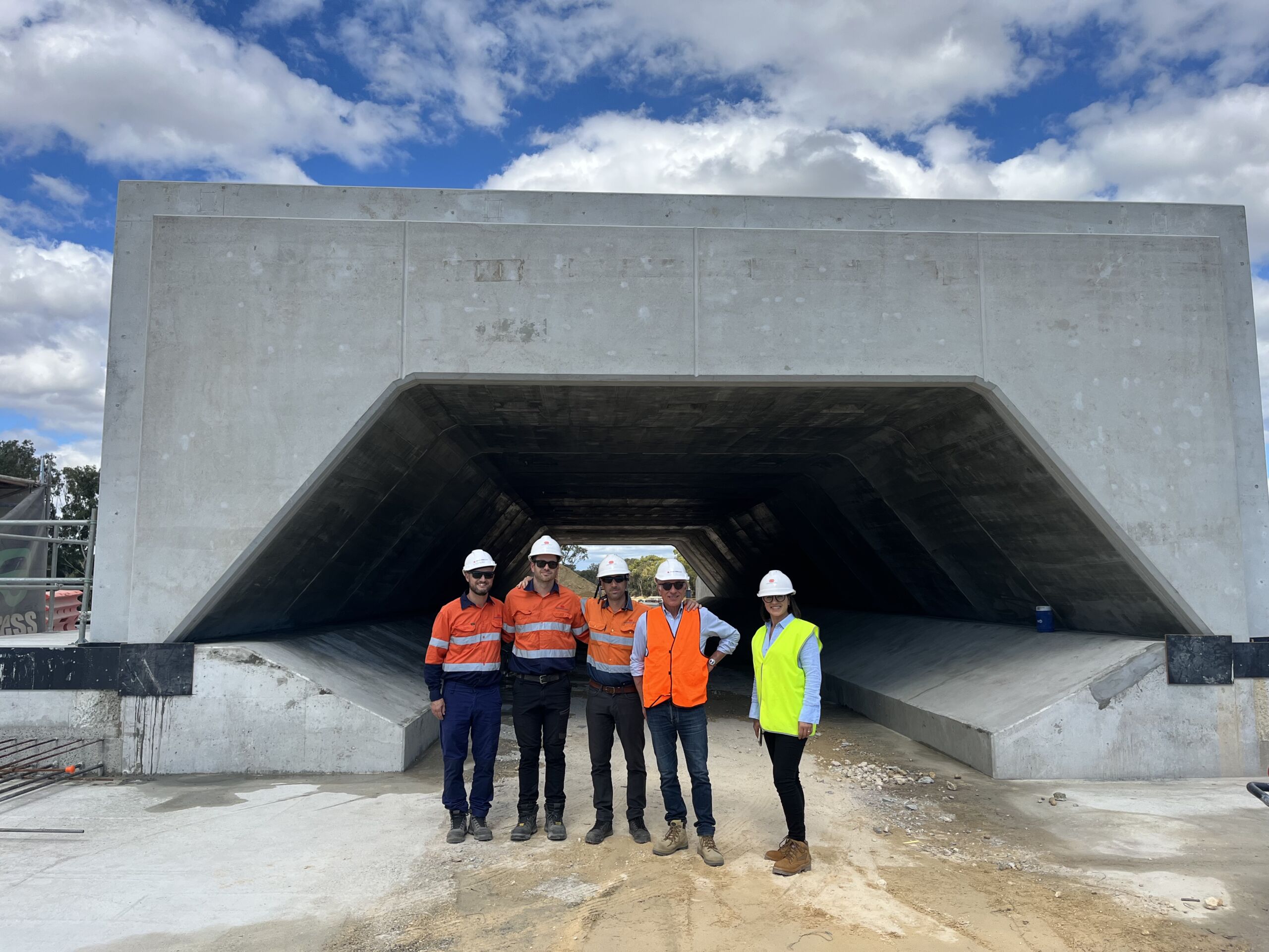 Geoquest Engineers in high vis vests stand in front of precast concrete structures at the road infrastrcutrue project, Stephenson Road Extension, at Perth's Mitchell Freeway.