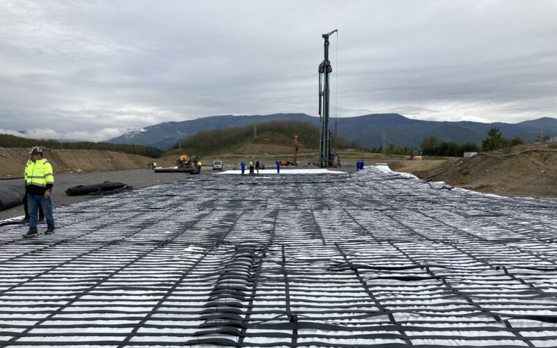 High-strength reinforcement geosynthetic, ArmaLynk by Geoquest Australia being installed in a mine site.