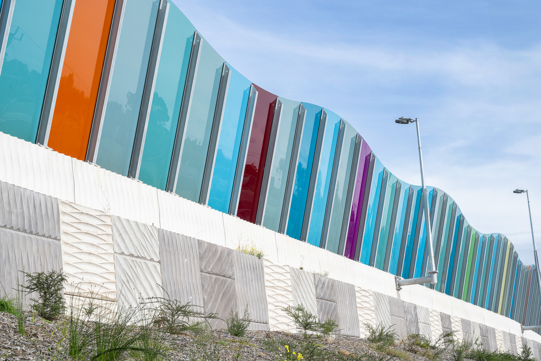 A reinforced earth wall (MSE wall) at the Sydney Gateway project, New South Wales, which has pre cast concrete facing panels with decorative elements engraved.